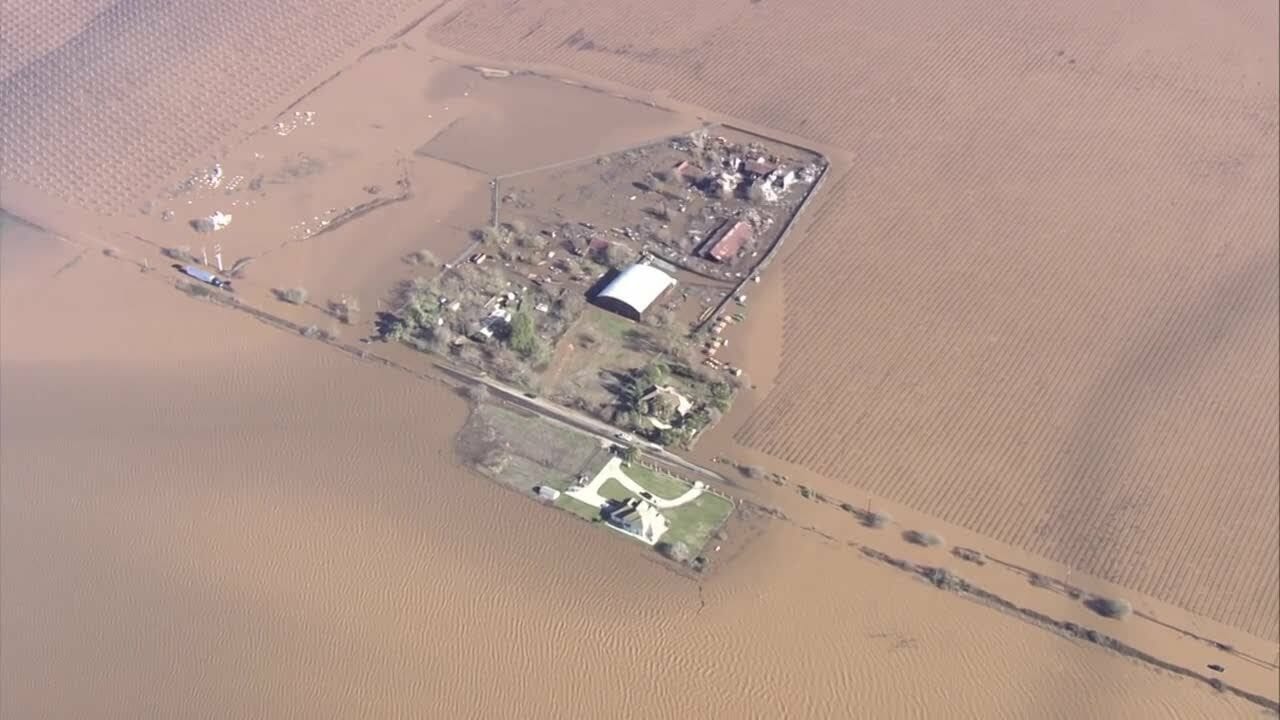 Chief Meteorologist Mark Finan surveys floodwaters in Sacramento County