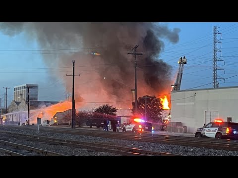 Heavy Flames And Black Smoke Shooting From Downtown Building